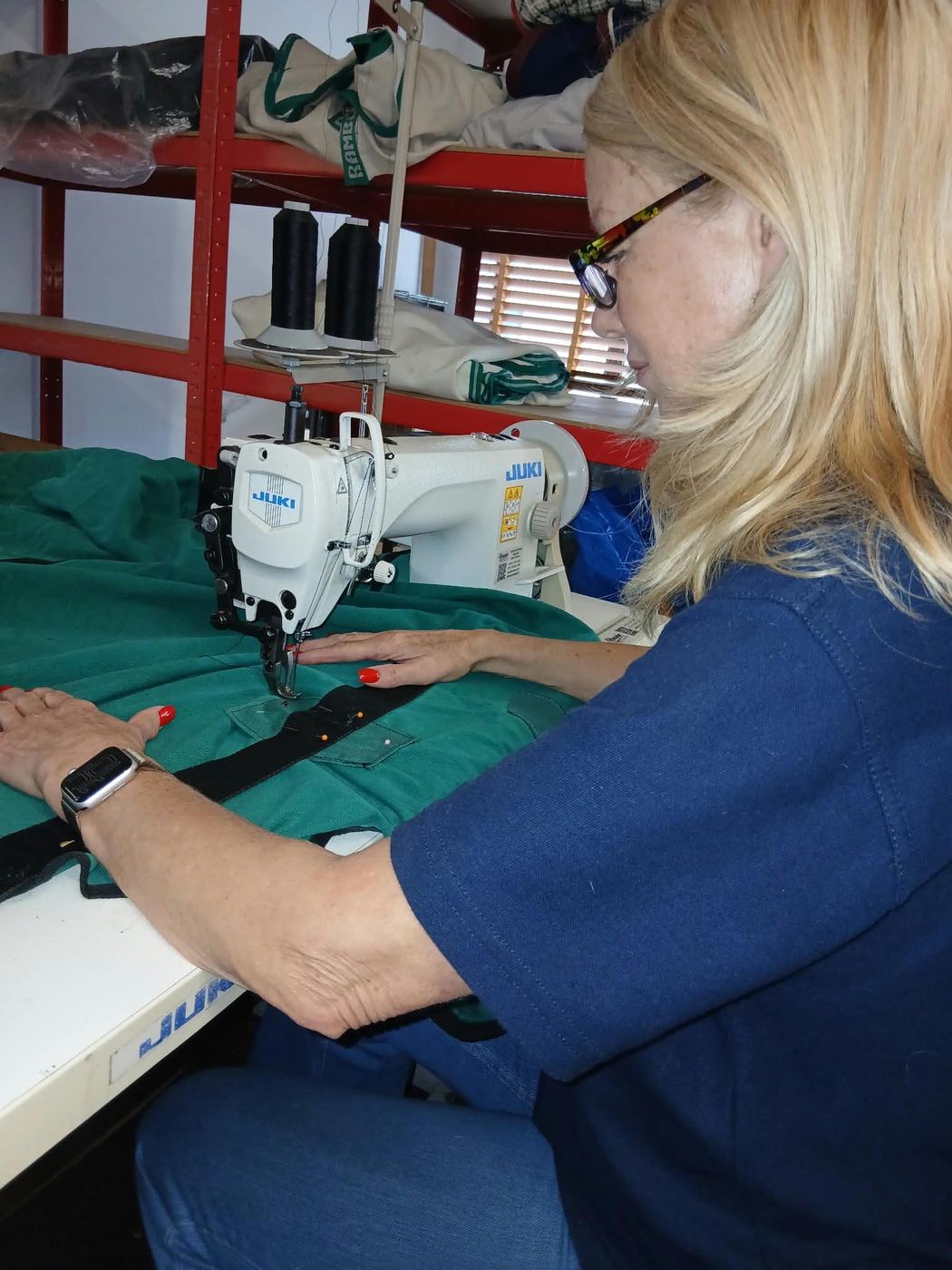 Kathy stitching a green rug on her Juki sewing machine