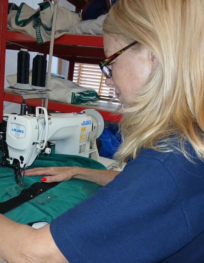 Kathy repairing a green horse rug on her Juki sewing machine