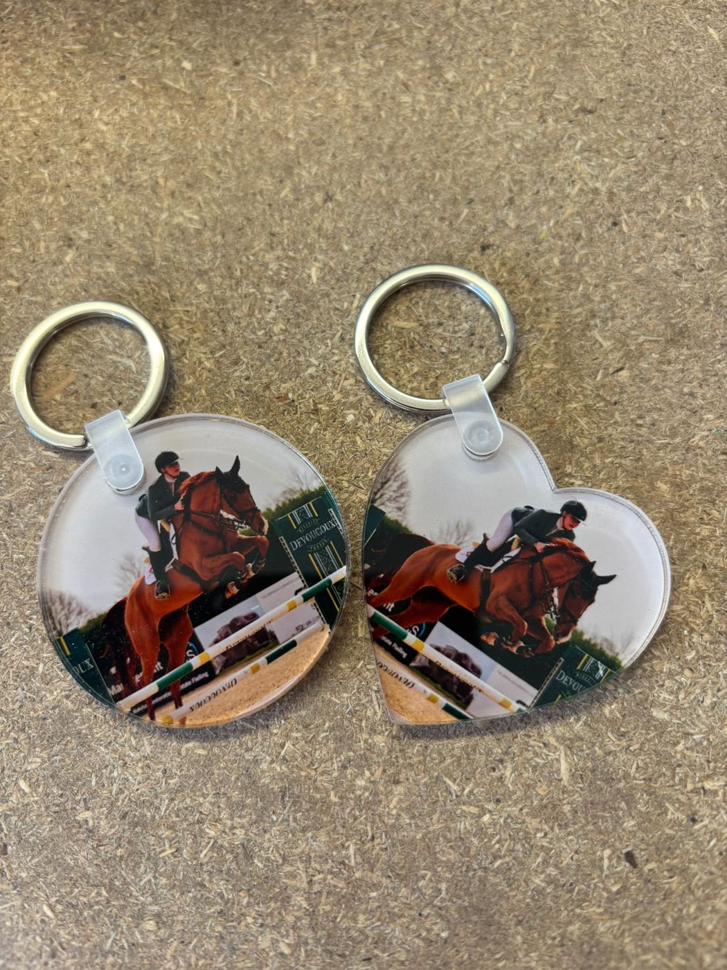 Round and heart-shaped photo keyrings of a horse jumping